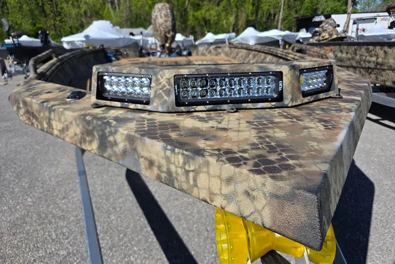 Slide: The Image of Camouflage-patterned Excel 183 Tomahawk boat with LED lights, 2026 model, outdoors. - 2