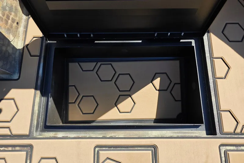 Slide: The Image of Open storage compartment with hexagonal pattern in Excel 183 Tomahawk, 2026 model. - 20