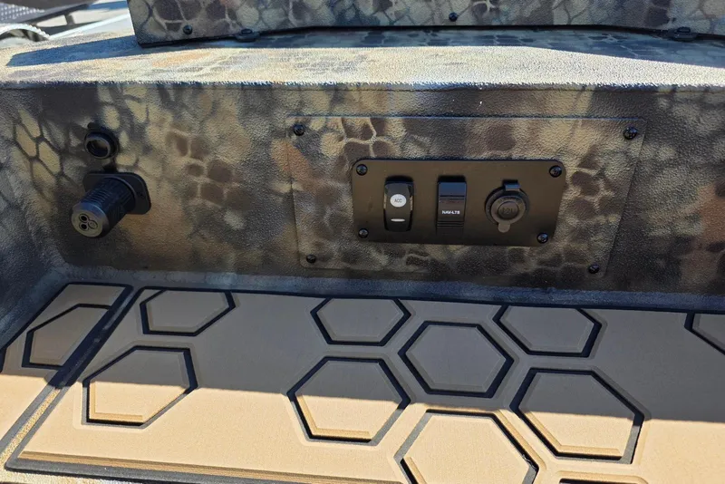 Slide: The Image of Control panel of 2026 Excel 183 Tomahawk boat with camouflage design and hexagonal floor pattern. - 21