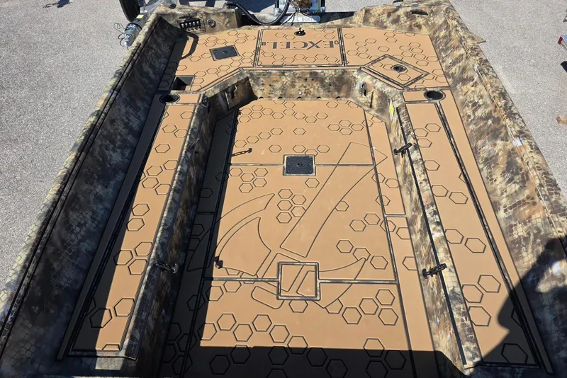 Slide: The Image of 2026 Excel 183 Tomahawk boat interior with hexagonal pattern and camouflage design. - 22