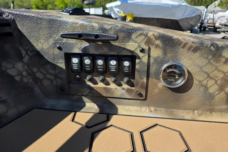 Slide: The Image of Control panel of 2026 Excel 183 Tomahawk boat with switches and fuel gauge. - 24