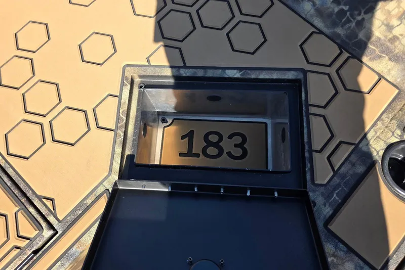 Slide: The Image of Hexagonal patterned surface with open compartment displaying number 183 on Excel 183 Tomahawk, 2026 model. - 27