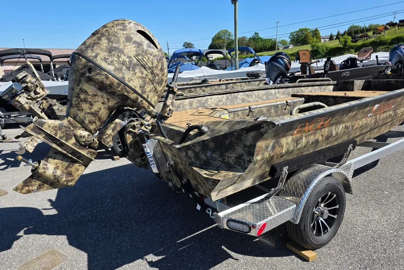Slide: The Image of Camouflage-patterned 2026 Excel 183 Tomahawk boat on trailer, displayed outdoors. - 3