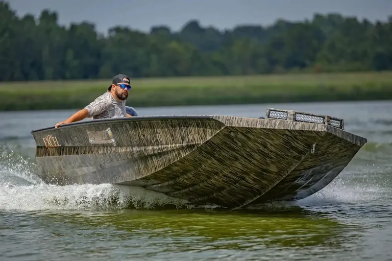 Slide: The Image of Manufacturer Provided Image: Man driving 2026 Excel 183 Tomahawk boat on a lake, creating a wake. - 31