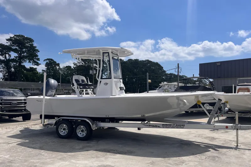 The Image of 2026 Tidewater 2210 Carolina Bay boat on trailer under blue sky. - 0