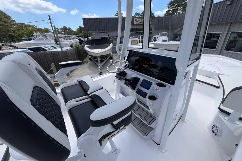 Slide: The Image of 2026 Tidewater 2210 Carolina Bay boat interior with modern helm and seating. - 11