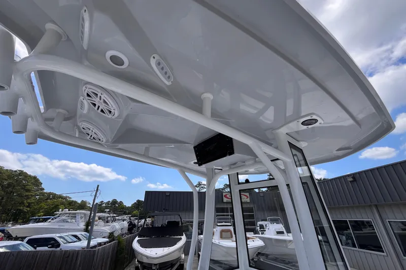 Slide: The Image of Tidewater 2210 Carolina Bay 2026 boat with T-top and speakers, displayed outdoors. - 12