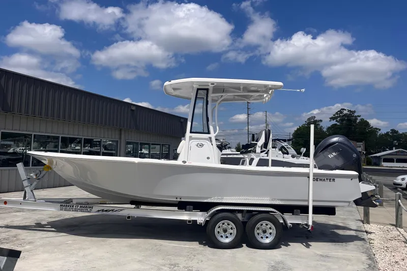 Slide: The Image of 2026 Tidewater 2210 Carolina Bay boat on trailer, displayed outdoors under a blue sky. - 2