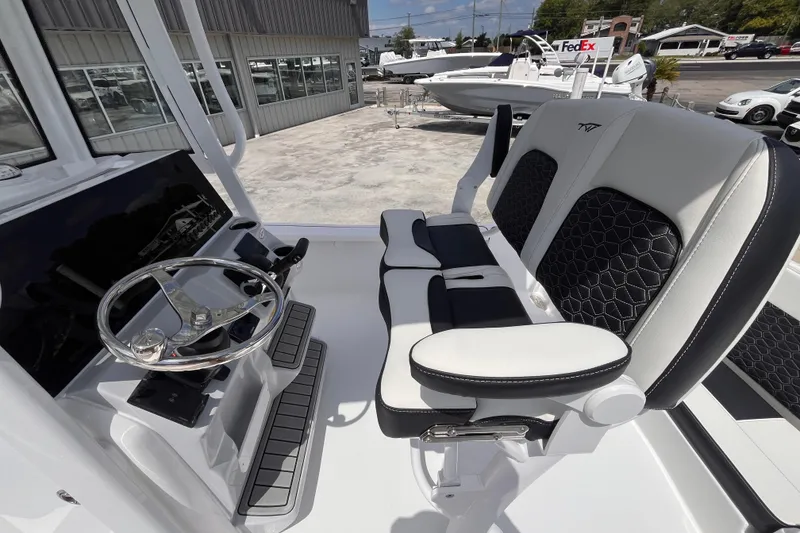 Slide: The Image of 2026 Tidewater 2210 Carolina Bay boat interior with sleek steering and comfortable seating. - 5