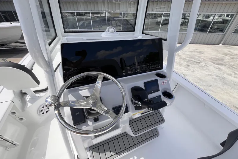 Slide: The Image of 2026 Tidewater 2210 Carolina Bay boat console with steering wheel and modern controls. - 6
