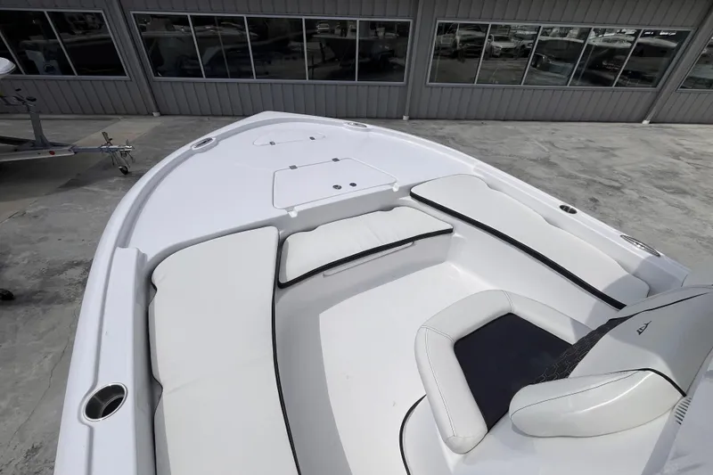 Slide: The Image of 2026 Tidewater 2210 Carolina Bay boat interior with cushioned seating and storage compartments. - 8