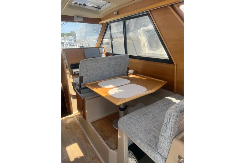 Slide: The Image of Interior of 2012 Cutwater 26 boat with dining area and wooden accents. - 5
