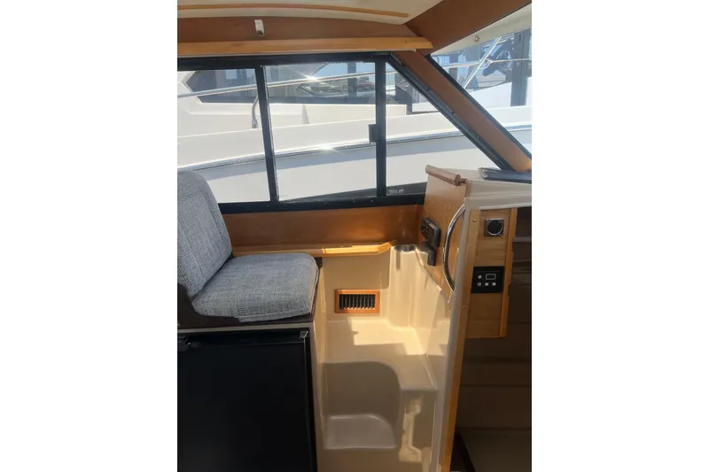 Slide: The Image of Interior of a 2012 Cutwater 26 boat, featuring a seat and control panel. - 7