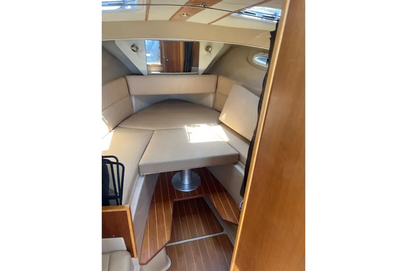 Slide: The Image of Interior cabin of 2012 Cutwater 26 boat with cushioned seating and wooden flooring. - 9