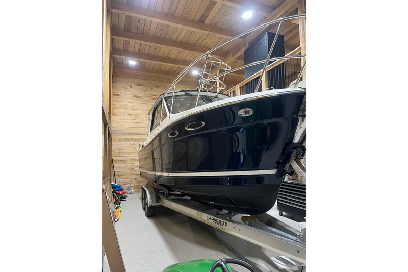 The Image of 2012 Cutwater 26 boat in wooden garage, on trailer, under bright lighting. - 0