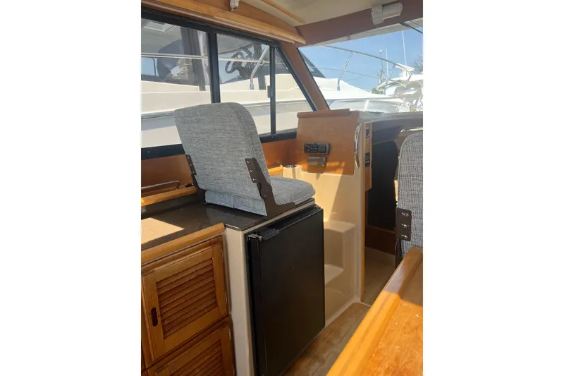 Slide: The Image of Interior of 2012 Cutwater 26 boat with seating and compact kitchenette. - 6