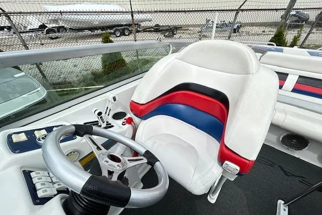 Slide: The Image of 2004 Formula 292 FASTech boat cockpit with steering wheel and colorful seat design. - 11