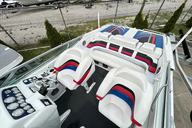 Slide: The Image of 2004 Formula 292 FASTech boat interior with white, red, and blue seating, and detailed dashboard. - 13