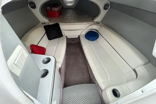Slide: The Image of Interior of a 2004 Formula 292 FASTech boat with white leather seating and colorful cushions. - 14