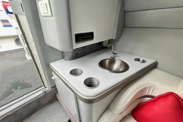 Slide: The Image of Interior of a 2004 Formula 292 FASTech boat featuring a compact sink and cup holders. - 15
