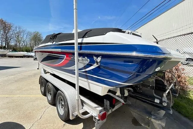 Slide: The Image of 2004 Formula 292 FASTech boat on trailer, blue and white design, parked outdoors. - 5