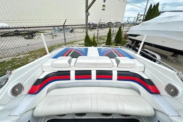 Slide: The Image of 2004 Formula 292 FASTech boat with colorful seating and sleek design in a marina setting. - 7