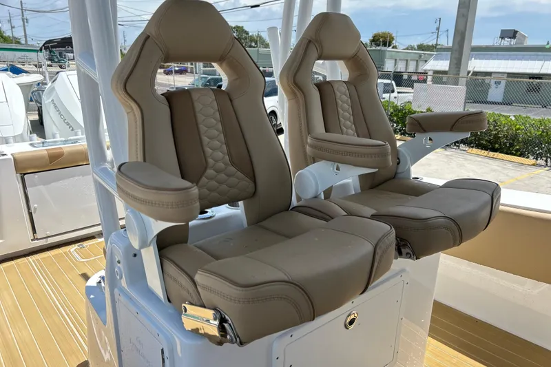 Slide: The Image of Luxury seating on 2025 Cape Horn 34 XS boat, featuring tan leather upholstery and armrests. - 10