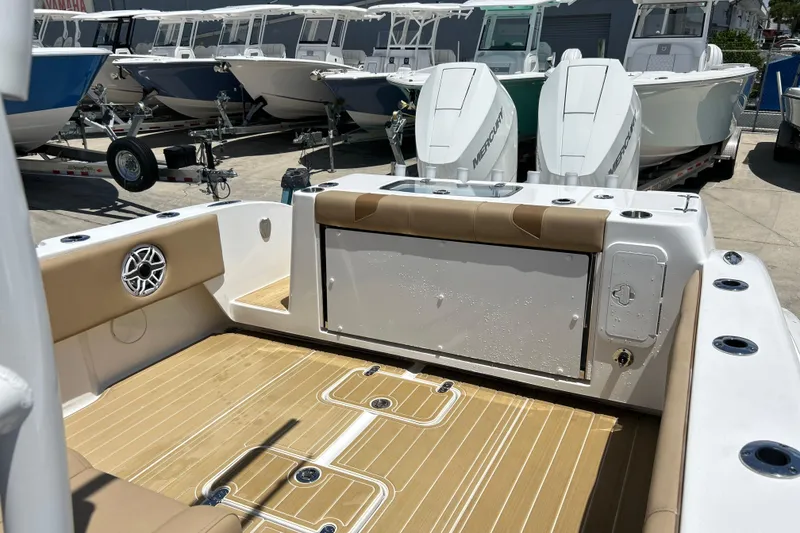 Slide: The Image of 2025 Cape Horn 34 XS boat interior with tan seating and dual Mercury engines. - 15