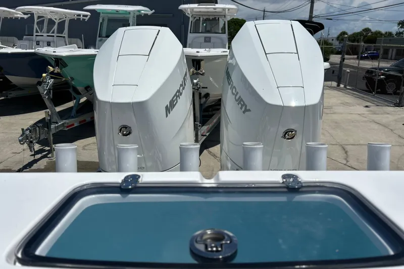 Slide: The Image of 2025 Cape Horn 34 XS boat with dual Mercury engines in a marina setting. - 20
