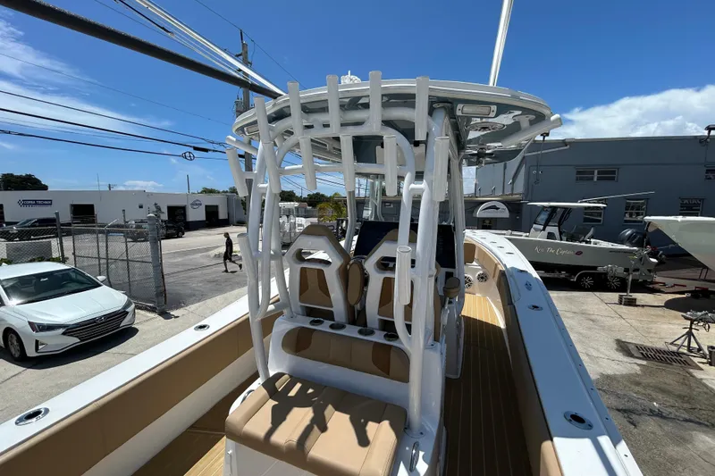Slide: The Image of 2025 Cape Horn 34 XS boat with modern helm and seating, docked under clear blue sky. - 26