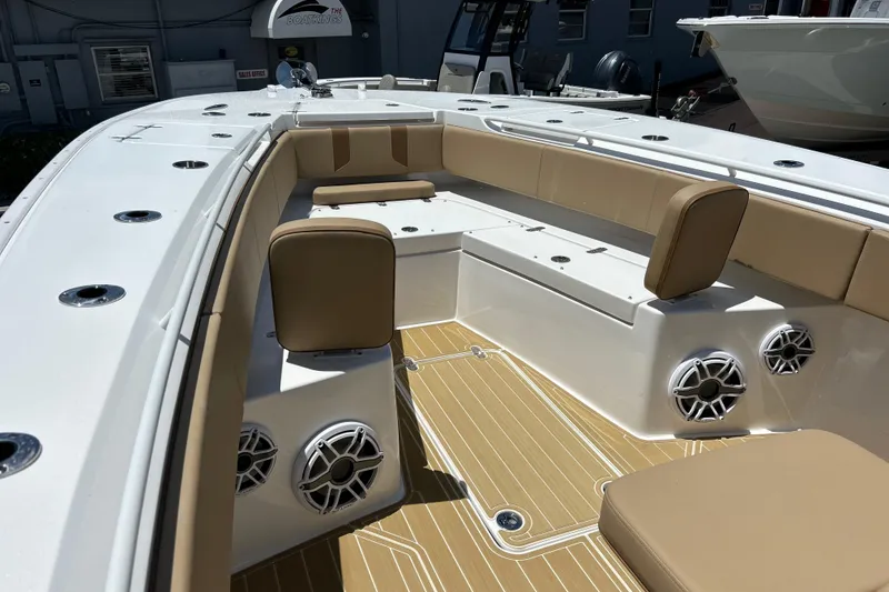 Slide: The Image of 2025 Cape Horn 34 XS boat interior with tan seating and marine speakers. - 27