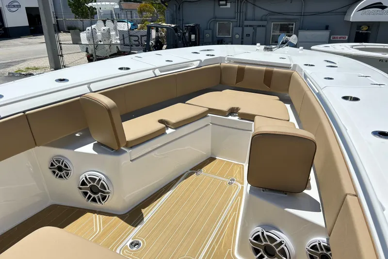 Slide: The Image of 2025 Cape Horn 34 XS boat interior with tan seating and wood-patterned flooring. - 34