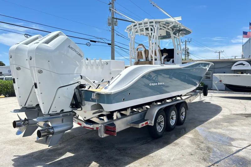 Slide: The Image of 2025 Cape Horn 34 XS boat with dual Mercury engines on a trailer. - 35