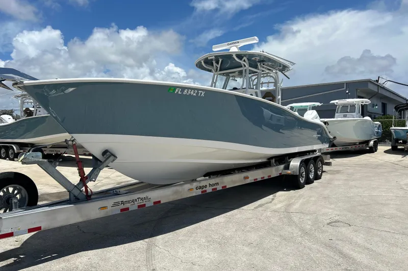 Slide: The Image of 2025 Cape Horn 34 XS boat on trailer, parked outdoors under a cloudy sky. - 37
