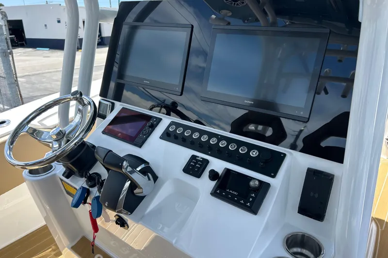Slide: The Image of 2025 Cape Horn 34 XS boat dashboard with dual Garmin screens and steering wheel. - 4