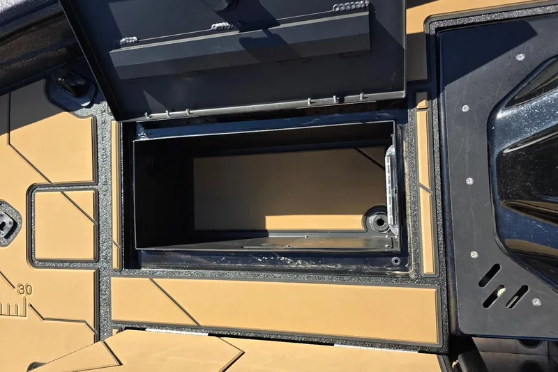 Slide: The Image of Open storage compartment on Excel EX 183 boat, 2026 model, with tan and black design. - 11