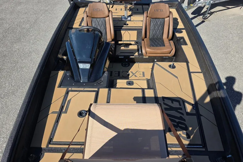 Slide: The Image of 2026 Excel EX 183 boat interior with brown seats and modern dashboard design. - 18