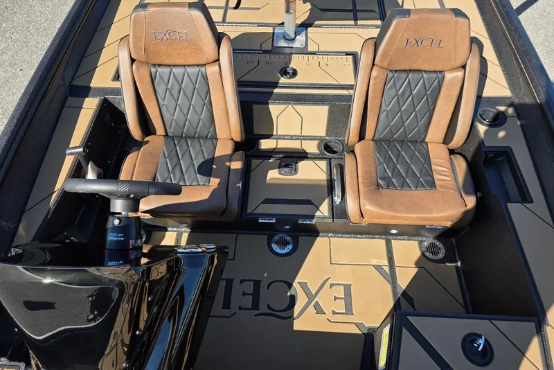 Slide: The Image of 2026 Excel EX 183 boat interior with brown and black leather seats, steering wheel, and deck design. - 19