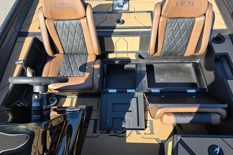 Slide: The Image of 2026 Excel EX 183 boat interior with brown and black seats, storage compartments open. - 20