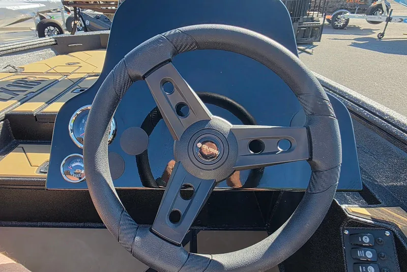 Slide: The Image of Steering wheel of 2026 Excel EX 183 boat with dashboard gauges and controls. - 21