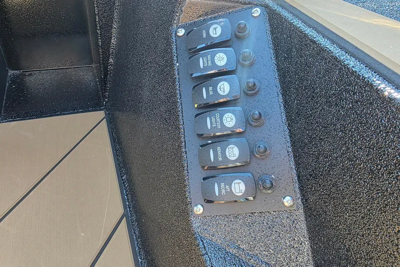 Slide: The Image of Control panel of Excel EX 183 boat, featuring multiple switches, 2026 model. - 23