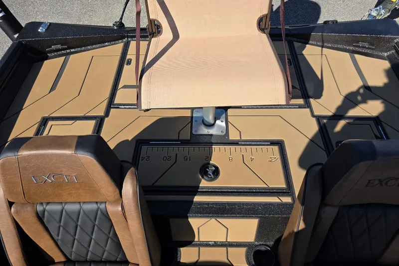 Slide: The Image of Interior of 2026 Excel EX 183 boat with tan and black seating and deck. - 25