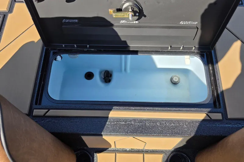 Slide: The Image of Open storage compartment in Excel EX 183 boat, 2026 model, with visible interior details. - 26