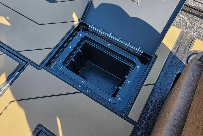 Slide: The Image of Open storage compartment on Excel EX 183 boat, 2026 model, with tan and black flooring. - 27