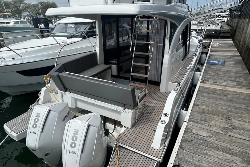 The Image of 2025 Beneteau Antares 11 Fly docked, featuring twin Mercury 300 V8 engines. - 0