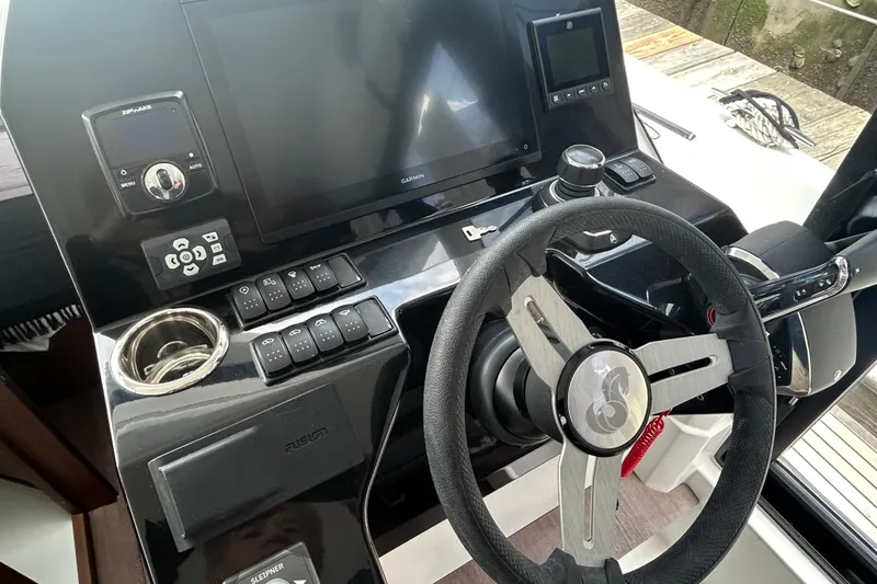 Slide: The Image of 2025 Beneteau Antares 11 Fly helm with steering wheel and navigation controls. - 3