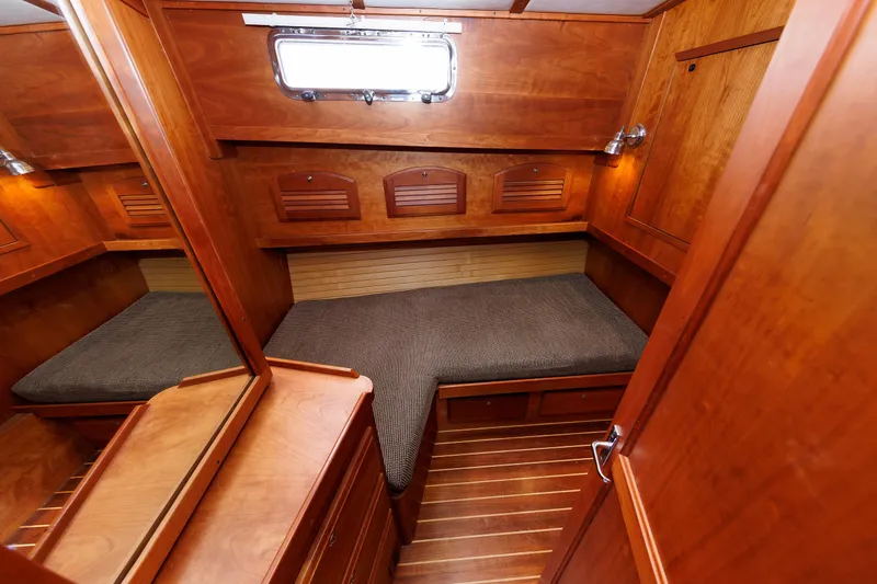 Slide: The Image of Cozy wooden cabin interior of 2004 Sabre 42 Express yacht with cushioned seating. - 12
