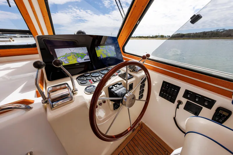 Slide: The Image of Helm of 2004 Sabre 42 Express yacht with navigation screens and wooden steering wheel. - 13
