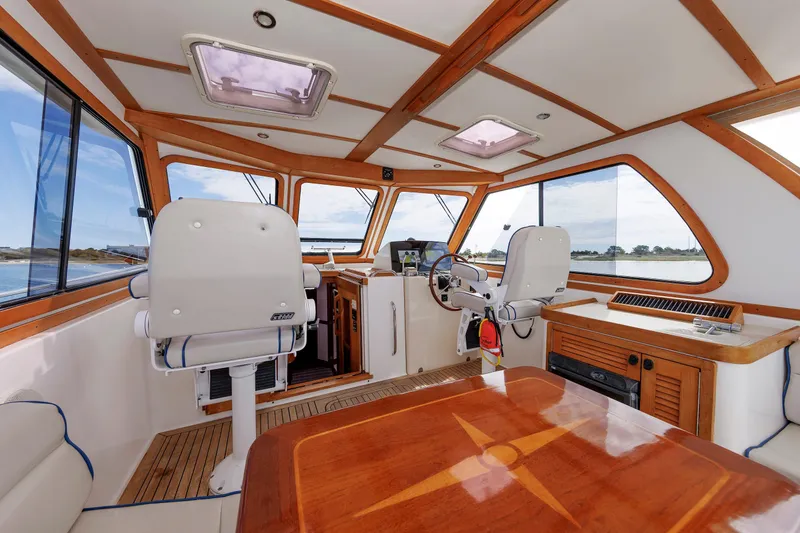 Slide: The Image of Interior of 2004 Sabre 42 Express yacht with elegant wood finish and modern helm. - 16