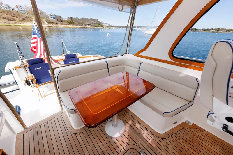 Slide: The Image of Luxurious 2004 Sabre 42 Express yacht interior with elegant seating and scenic waterfront view. - 18